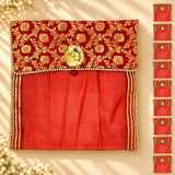 Red embroidered fabric saree cover pouch with gold floral patterns pearl trim and button closure for storage organization