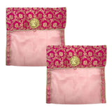 Two pink fabric saree covers with embroidered magenta and gold borders and golden floral embellishments for storage