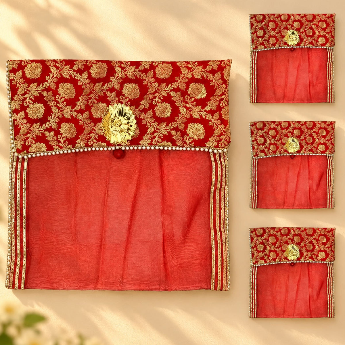 Red embroidered fabric saree cover with gold floral patterns and central golden clasp for wardrobe storage and travel