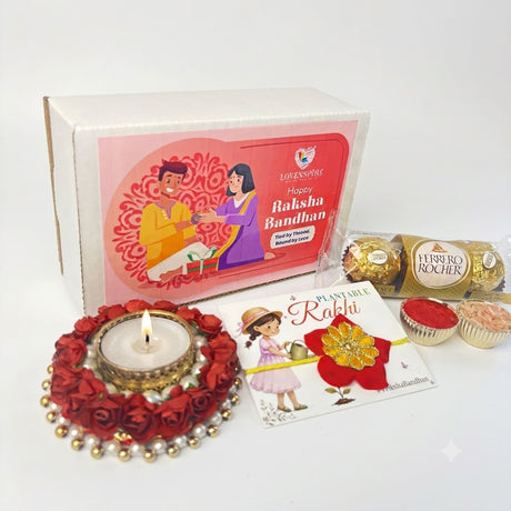 Red floral diya with lit candle and gold accents in flower shaped seed rakhi gift hamper for brother