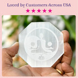 Selenite charging plate octagonal translucent crystal with frosted etched meditation figures and lotus flower design