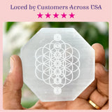A translucent octagonal white selenite charging plate with flower of life and chakra symbols for crystals and healing stones