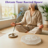 A translucent octagonal selenite crystal plate with engraved face design for crystal charging and home decor