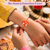 Orange car-shaped rakhi bracelet with white circular details on red thread for brother raksha bandhan gift and protection