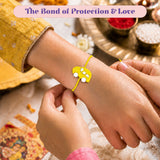 Yellow car-shaped rakhi with white circular details on a yellow string for raksha bandhan brother gift bracelet