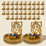 Golden ornate ganesha-themed tea light candle holders with intricate cut-out designs and decorative bases for diwali decor