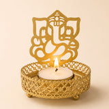 Golden metal ganesha-themed tea light candle holder with intricate lattice design and three small feet for diwali pooja decor