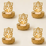 Gold-colored intricately designed ganesha themed tea light candle holders with mesh pattern and small feet for diwali decor
