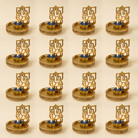 Golden ganesha-themed tea light candle holders with intricate cut-out designs and ornate patterned bases for diwali decor