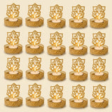 Golden ganesha-themed tea light candle holders with intricate cut-out designs and textured bases for diya decor