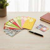 Colorful gold-embossed Shagun Maharaja envelopes fanned on wood