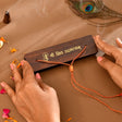 Wooden plaque with gold Shiv Rudrashtakam script and trident on pocket prayer book