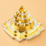 Golden and silver metallic sri yantra pyramid sculpture made of brass for good luck wealth and spiritual meditation decor