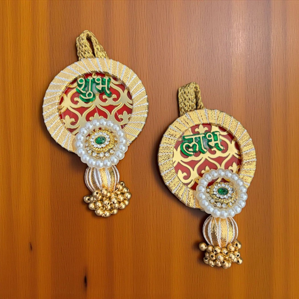 Decorative round wall hangings with gold borders, pearls, emeralds, and golden bells