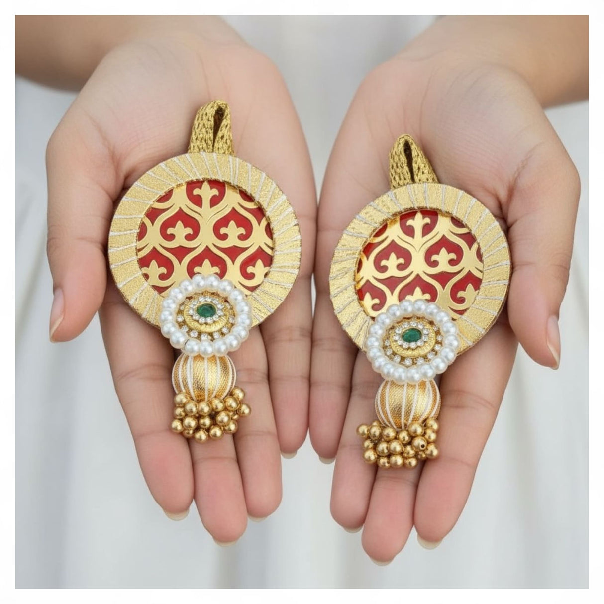 Gold and red ornate dangling earrings with pearls and emeralds for Indian traditional decor