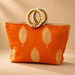 Orange satin silk tote bag with gold leaf embroidery and pearl adorned golden handles for Eid and wedding favors