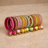 A vibrant collection of colorful silk thread bangles with kundan gold embellishments for Indian wedding fashion