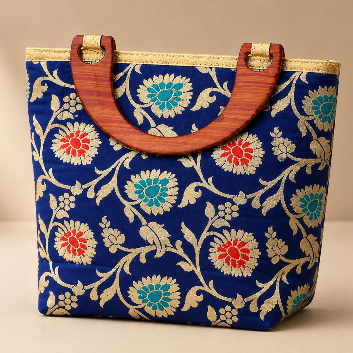 Traditional Indian embroidered silk blue handbag with red teal gold floral patterns and wooden handles for festivals and weddings