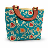 Teal silk fabric tote bag with red and gold floral embroidery wooden handles and brass zipper for ethnic festival use