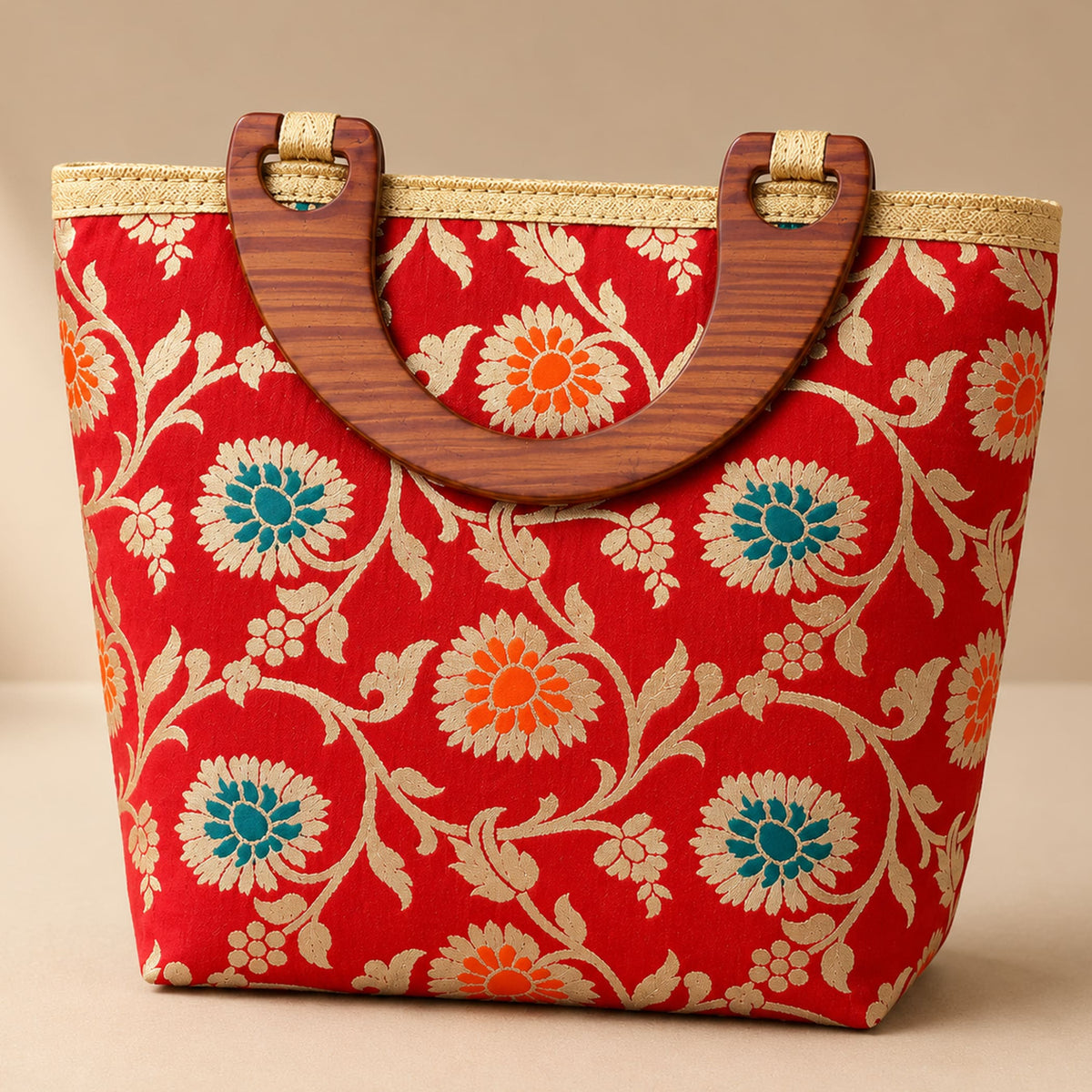 Traditional Indian embroidered silk red woven handbag with teal and orange floral pattern and wooden handles for festivals