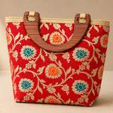 Traditional Indian embroidered silk red woven handbag with teal and orange floral pattern and wooden handles for festivals
