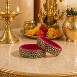 Vibrant fuchsia Indian silk thread bangles with intricate gold-tone floral patterns and sparkling rhinestones for women