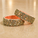 Ornate peach-colored Indian silk thread bangles with gold-toned settings and sparkling marquise-cut stones for women