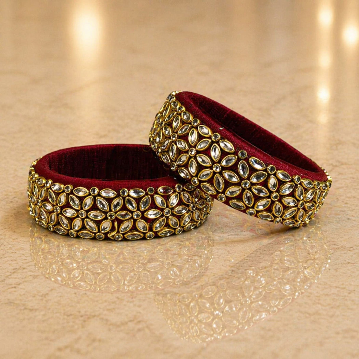 Elegant maroon velvet indian silk thread bangles adorned with gold-toned metalwork and sparkling kundan stones