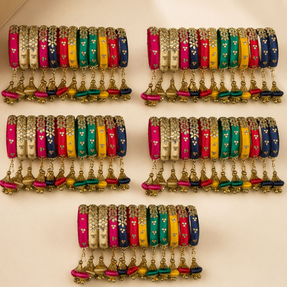 Vibrant multi-colored silk thread bangles with gold floral embroidery and dangling tassels for Indian wedding jewelry