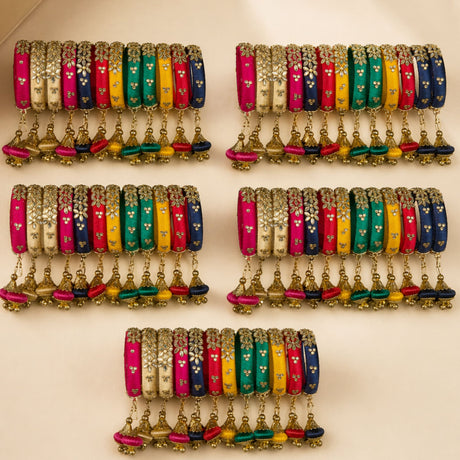 Vibrant multi-colored silk thread bangles with gold floral embroidery and dangling tassels for Indian wedding jewelry