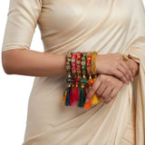 A set of five vibrant silk thread bangles with kundan-style embroidery and multicolor tassels for weddings and festivals