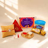 Gold-colored heart-shaped haldi kumkum holder with red and white powders in pure silver bhai dooj gift hamper
