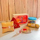 Yellow woven fabric pillow with red and white rakhi bracelet included in pure silver ganesha rakhi gift hamper for brother