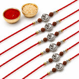 Designer silver tone Ganesha rakhi with red cord and brown beads for brother and bhabhi on Raksha Bandhan