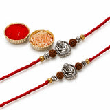 Red braided thread rakhi with silver tone ganesha charms and brown rudraksha beads for raksha bandhan protection