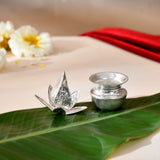 Silver plated mini mangal kalash with lotus shaped offering holder and silver pot on green leaf for pooja and decor
