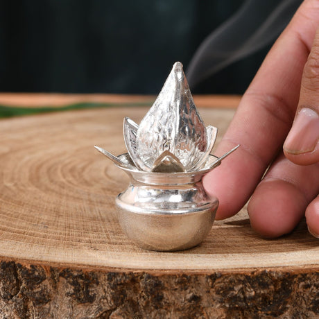 Silver plated mini mangal kalash shaped like a lotus with textured petals emitting smoke for pooja and home decor