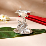 Silver plated peacock diya with intricate detailing and scalloped petal top for home pooja mandir and Diwali decor