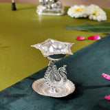 Silver plated peacock diya oil lamp with star-shaped top and ornate base for home pooja mandir and Diwali decor