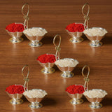 Silver colored ornate miniature silver plated haldi kumkum holder with handle and pedestal base for puja use