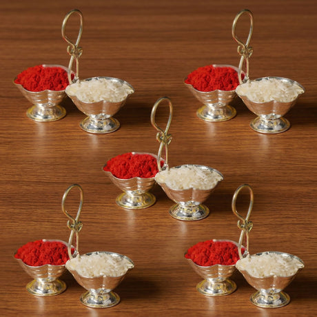 Silver colored ornate miniature silver plated haldi kumkum holder with handle and pedestal base for puja use