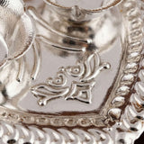 Silver plated haldi kumkum holder with intricate floral and geometric embossed patterns for home temple decor