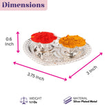 Silver plated heart shaped haldi kumkum holder with two ornate scalloped bowls containing red and orange powders