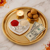 Silver plated haldi kumkum holder with gold heart shaped tray and intricate silver detailing holding red powder and rice