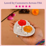 Silver plated heart shaped haldi kumkum holder with two compartments containing red and orange powders for puja decor