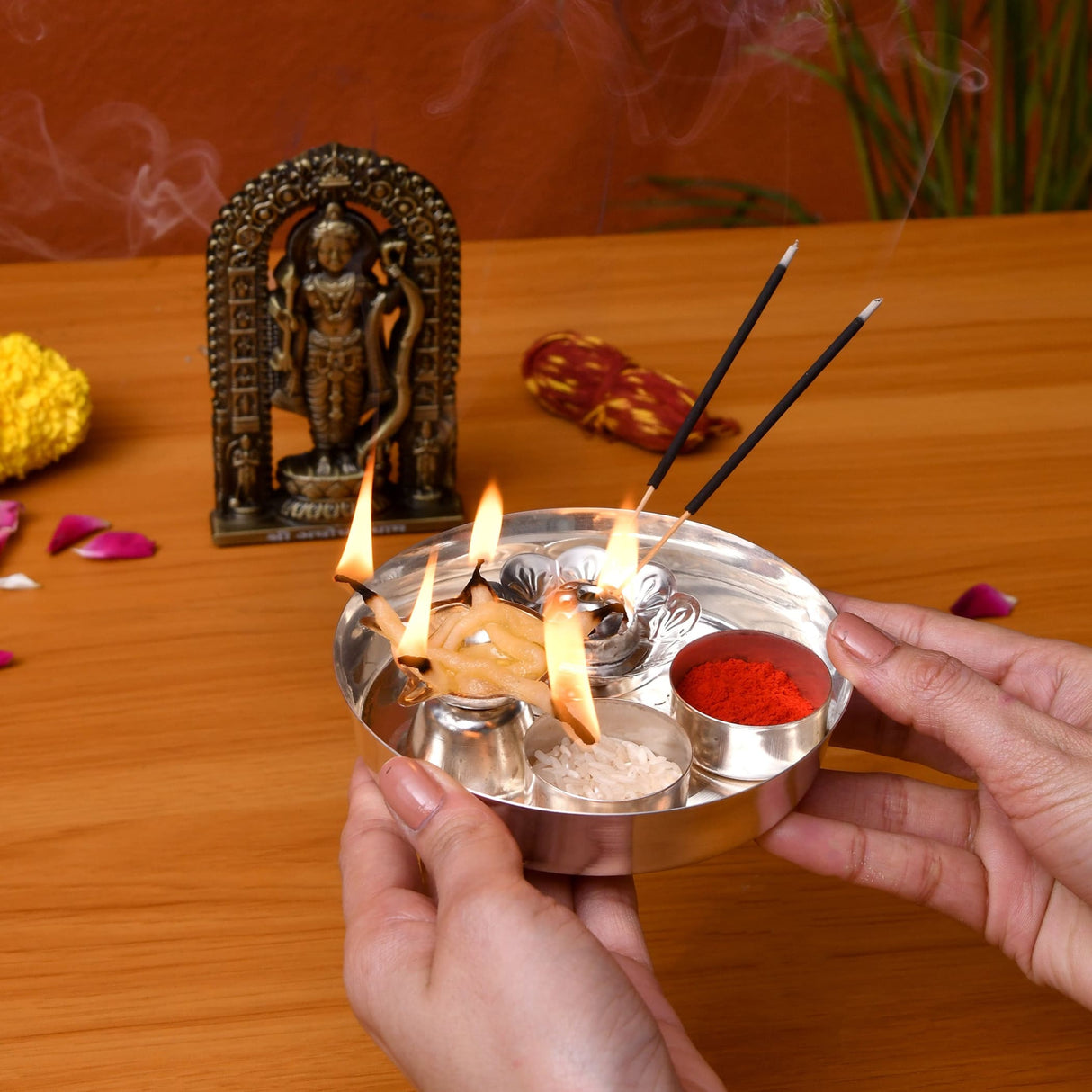 Silver plated pooja thali set featuring a silver metallic incense burner with compartments holding burning sticks red powder and white granules