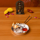 Silver plated pooja thali set with three compartments holding incense sticks burning oil lamps and red powder for rituals