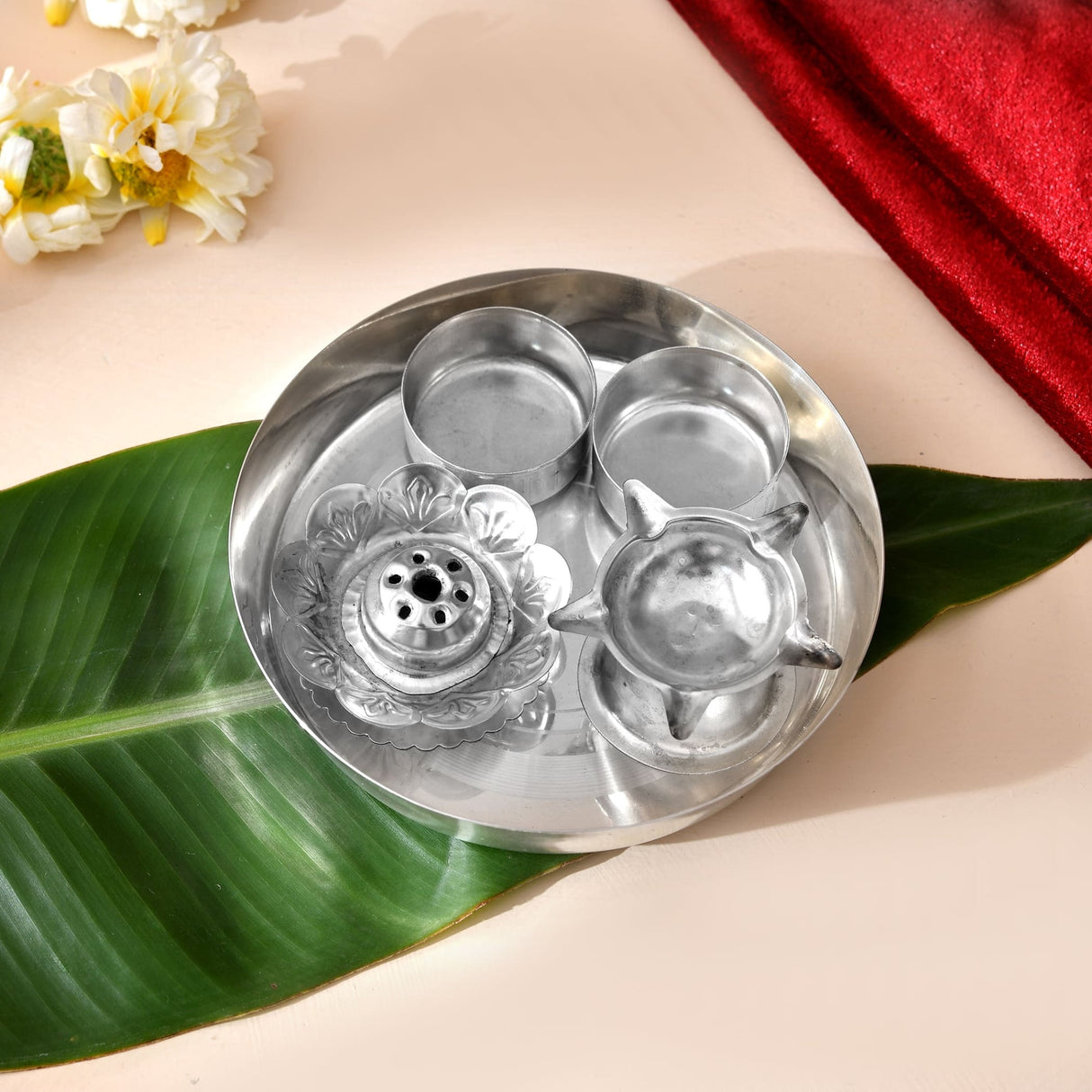 Shiny silver plated 5-piece pooja thali set with intricate floral and star designs for Indian religious rituals