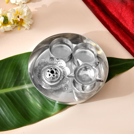 Shiny silver plated 5-piece pooja thali set with intricate floral and star designs for Indian religious rituals