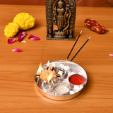 Silver plated 5-piece pooja thali set with multiple compartments holding incense sticks burning oil lamps red powder and grains